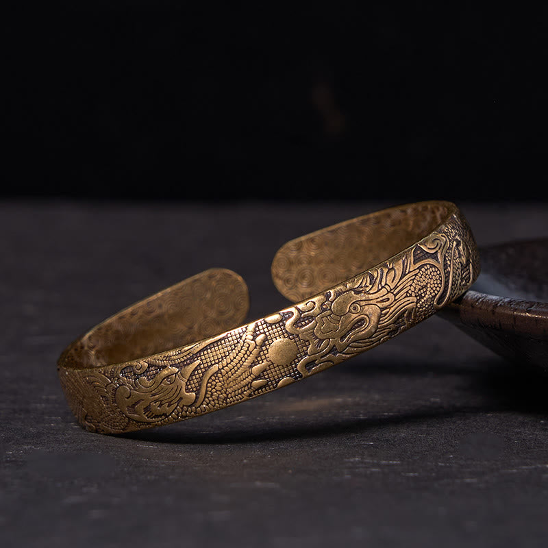 Bracelet jonc porte-bonheur en cuivre et laiton sculpté motif Dragon et Phénix jouant avec une perle Foviel