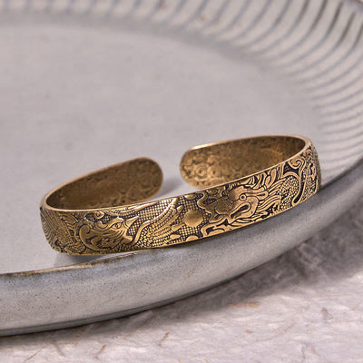 Bracelet jonc porte-bonheur en cuivre et laiton sculpté motif Dragon et Phénix jouant avec une perle Foviel