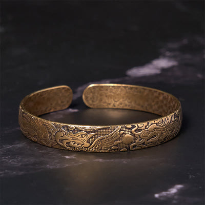 Bracelet jonc porte-bonheur en cuivre et laiton sculpté motif Dragon et Phénix jouant avec une perle Foviel
