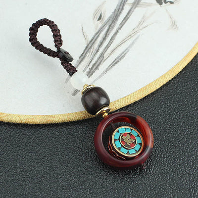 Buddha Stones Ebony Wood Sanskrit Four-leaf Clover Buddha's Eye Peace Rotatable Key Chain - image 1