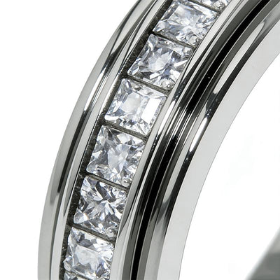 Close detail of clear square faceted stones, central channel and polished ring edges.
