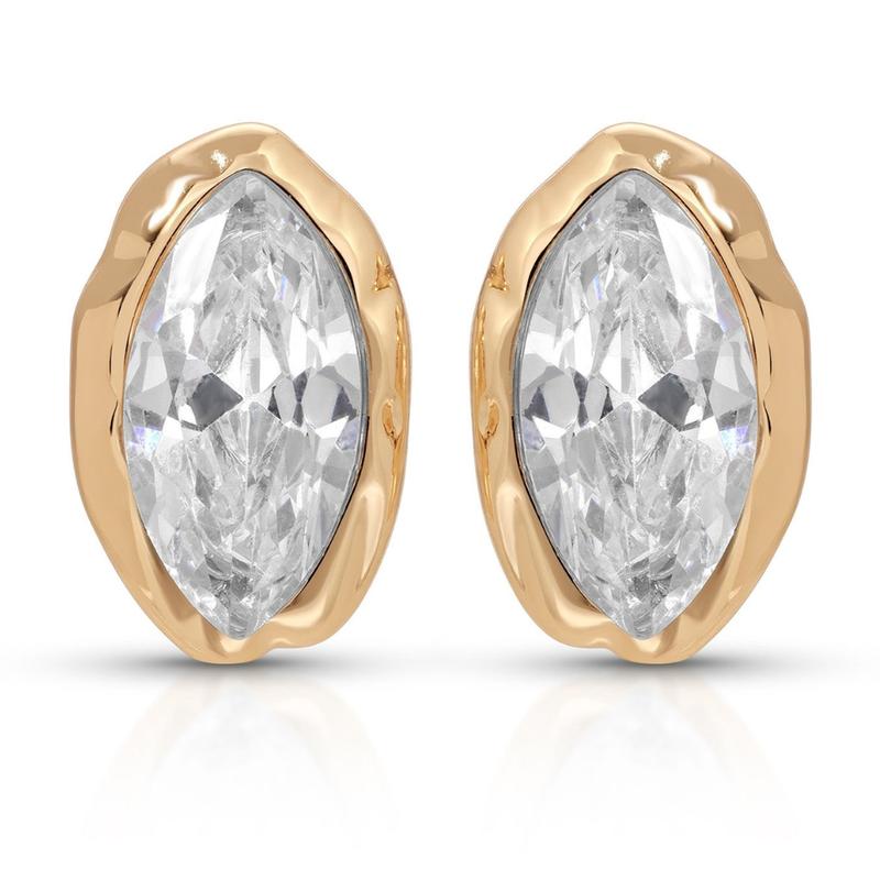 Pair of clear marquise faceted studs in organic gold-tone settings on white.